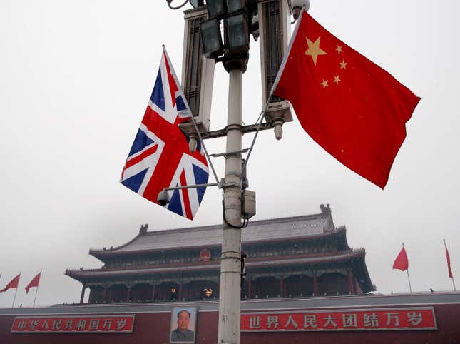 FILE - British and Chinese national flags are seen on display in front of the Tiananmen Gate in Beijing, China, Jan. 17, 2008. Beijing confirmed Friday, Jan. 26, 2024, that longtime British businessperson Ian J. Stones in China had been sentenced to five years in prison in 2022 on an espionage charge. (AP Photo/Andy Wong, File)