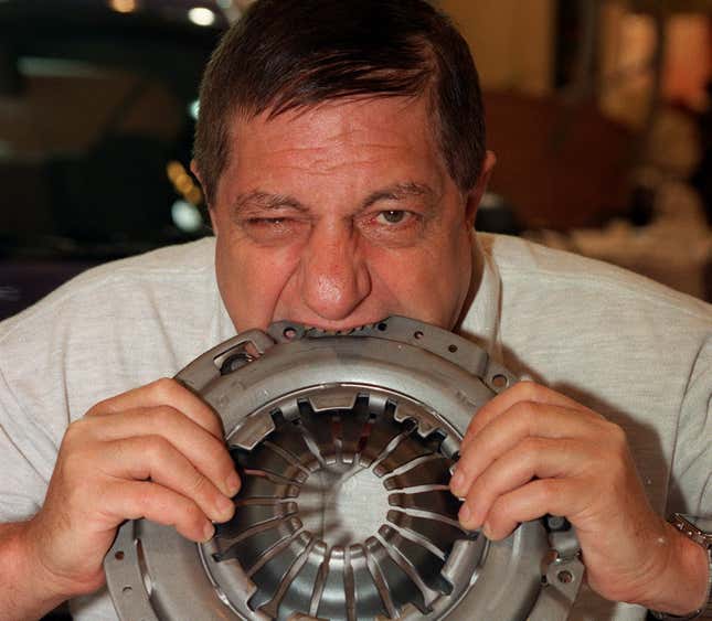 A man bites a car's clutch pressure plate.