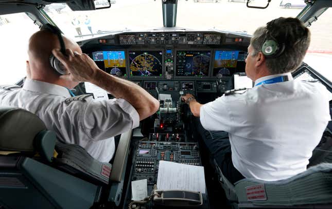 File - Pilots conduct a pre-flight check in the cockpit of a jet before taking off from Dallas Fort Worth airport in Grapevine, Texas, on Dec. 2, 2020. Aviation experts say the incident on Sunday in which an off-duty pilot, riding in a jump seat in a cockpit, tried to disable a jetliner in midflight renews questions about the threat posed by airline workers who have special access to places where passengers can&#39;t go. (AP Photo/LM Otero, File)