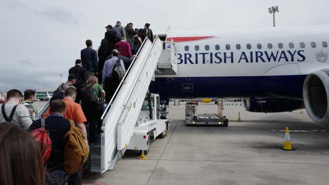A photo of people boarding on the left hand side of a plane. 