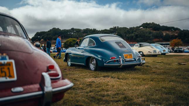 A pair of Porsche 356s are parked on grass.