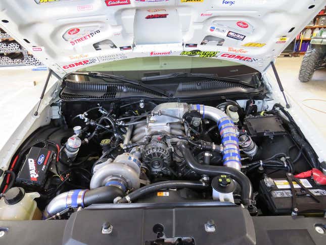 An under-hood shot of the Lincoln showing all the aftermarket equipment