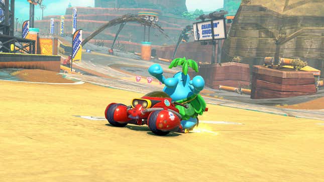 Pianta raises two fists in the air while sitting in a kart.
