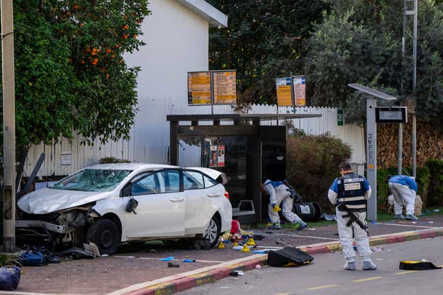 Israeli security forces work at the site of a Palestinian car-ramming and stabbing attack at a bus stop, in Ra&#39;anana, Israel, Monday, Jan. 15, 2024. Israeli police say a car-ramming and stabbing attack by Palestinians killed a woman and wounded at least 12 others north of Tel Aviv. (AP Photo/Oded Balilty)