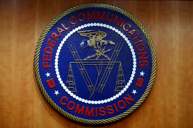 FILE - The seal of the Federal Communications Commission (FCC) is seen before an FCC meeting to vote on net neutrality, Dec. 14, 2017, in Washington. On Wednesday, Nov. 15, 2023, the FCC enacted new rules intended to eliminate discrimination in access to internet services, a move which regulators are calling the first major U.S. digital civil rights policy. (AP Photo/Jacquelyn Martin, File)