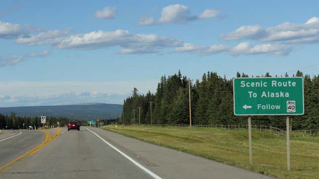 A photo of a "scenic route" sign on a highway. 