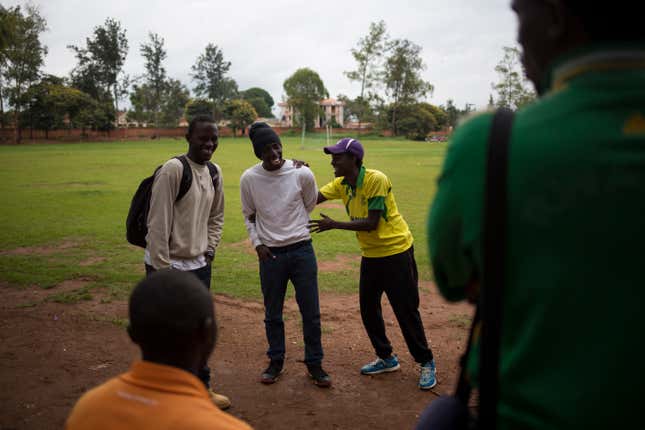 Team mates from the Rwandan cricket team share a joke.