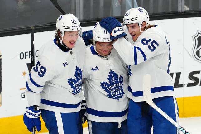 Feb 22, 2024; Las Vegas, Nevada, USA; Toronto Maple Leafs center Max Domi (11) celebrates with left wing Tyler Bertuzzi (59) and defenseman William Lagesson (85) after scoring a goal against the Vegas Golden Knights during the first period at T-Mobile Arena.