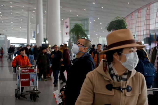A man wearing a mask for protection against air pollution looks at a flight information board at the Beijing Capital International Airport as the capital of China is shrouded by heavy smog on Dec.21, 2016. Beijing and much of industrial northern China are in the midst of a "red alert," the highest level in China's four-tiered pollution warning system. The alert has affected 460 million people, according to Greenpeace East Asia, which calculated that about 200 million people were living in areas that had experienced levels of air pollution more than 10 times above the guideline set by the World Health Organization. (AP Photo/Andy Wong)