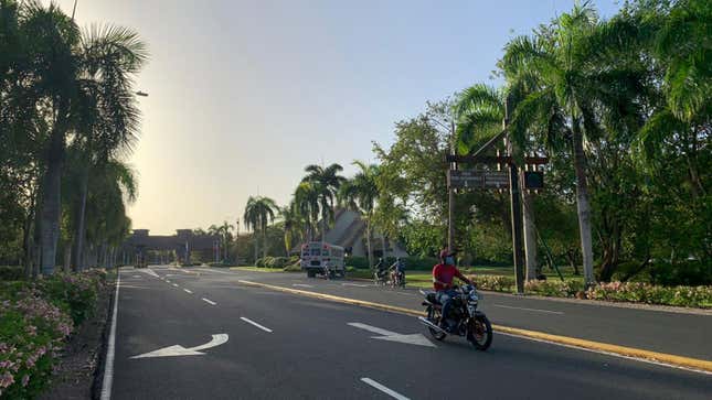 A photo of a moped driving down an empty highway.