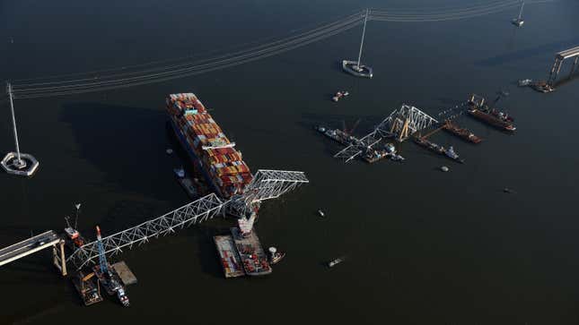 A photo of a container ship crashed into a bridge. 