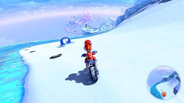 Yoshi sits on a bike in a snowy environment.