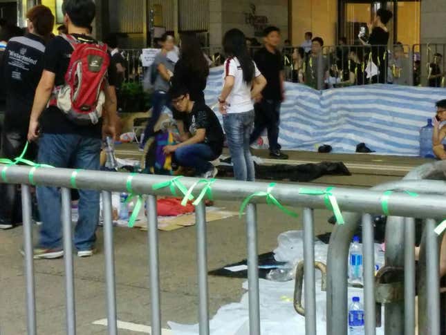 Protesters tied green ribbons along fences Causeway Bay, in Hong Kong, to symbolize police and protesters coming together.