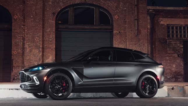 A black Aston Martin SUV with black wheels. 