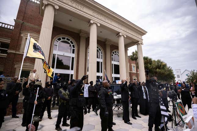 Dozens of Black Lives Matter and Black Panther protesters gather outside the Glynn County Courthouse where the trial of Travis McMichael, his father, Gregory McMichael, and William “Roddie” Bryan is held, Monday, Nov. 22, 2021, in Brunswick, Ga. The three men charged with the February 2020 slaying of 25-year-old Ahmaud Arbery. 