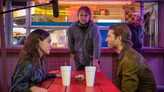 Adria Arjona, Richard Linklater, and Glen Powell on the set of Hit Man