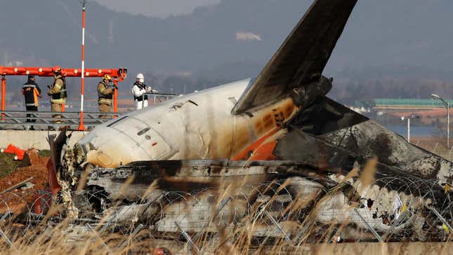 Firefighters work at the wreckage of a passenger plane at Muan International Airport on December 30, 2024 in Muan-gun, South Korea.