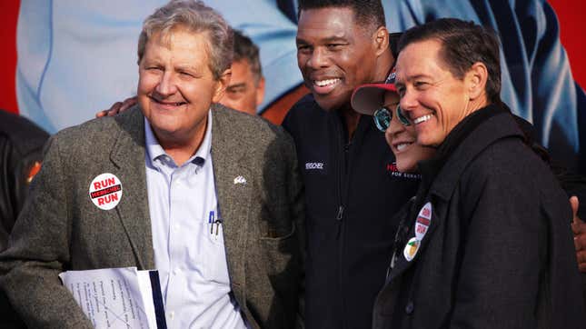 LOGANVILLE, GEORGIA - DECEMBER 04: Georgia Republican senate candidate Herschel Walker (2nd L) poses with his wife Julie Blanchard (3rd L) U.S. Sen. John Kennedy (R-LA) (L) and former executive director of the Christian Coalition Ralph Reed (R) during a campaign rally on December 4, 2022 in Loganville, Georgia. Herschel Walker continued to campaign throughout Georgia in hopes of defeating incumbent Sen. Raphael Warnock (D-GA) in the upcoming runoff election on December 6. (Photo by Alex Wong/Getty Images)