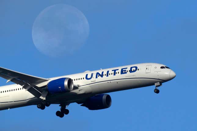 FILE - A United Airlines Boeing 787 approaches for landing in Lisbon, Sept. 2, 2023, with the setting moon in the background. An Airbus plane operated by United Airlines cut short a flight after crews got a door-indicator warning, according to a spokesperson for the airport in Tampa, Florida. United said Thursday, Jan. 11, 2024, that the plane took off later “after the issue was addressed.” (AP Photo/Armando Franca, File)