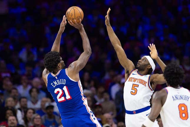Apr 25, 2024; Philadelphia, Pennsylvania, USA; Philadelphia 76ers center Joel Embiid (21) shoots past New York Knicks forward Precious Achiuwa (5) during the first half of game three of the first round for the 2024 NBA playoffs at Wells Fargo Center.