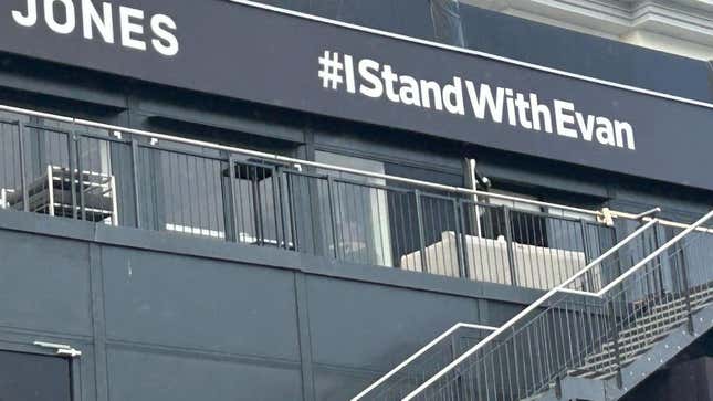 An #IStandWithEvan hashtag is wrapped on a building