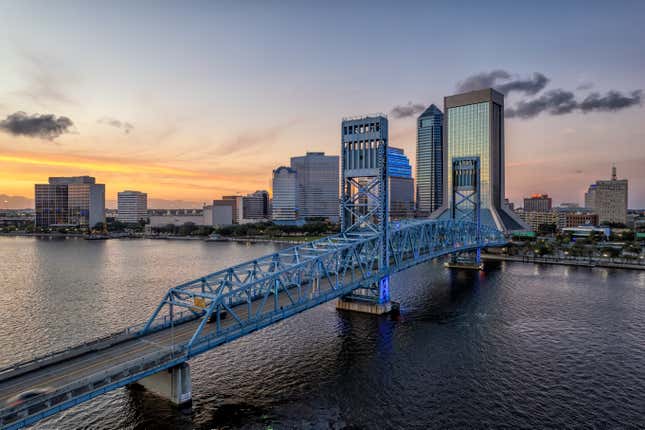 Aerial view of Jacksonville cityscape at dusk.