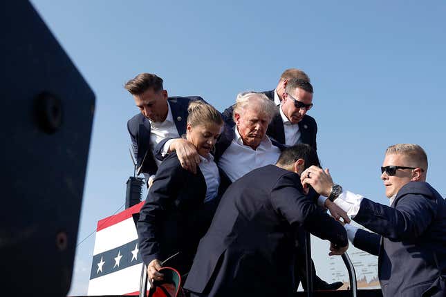 Republican presidential candidate former President Donald Trump pumps his fist as he is rushed offstage during a rally on July 13, 2024 in Butler, Pennsylvania. 