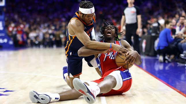 Josh Hart of the New York Knicks and Tyrese Maxey of the Philadelphia 76ers challenge for the ball during an NBA Playoff game