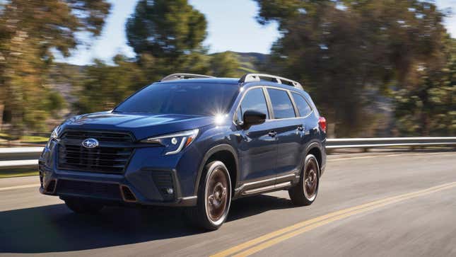 a dark blue Subaru Ascent suv driving on a curved roadway