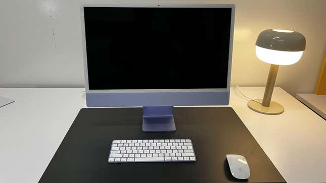 The Apple iMac set up on a desk. 