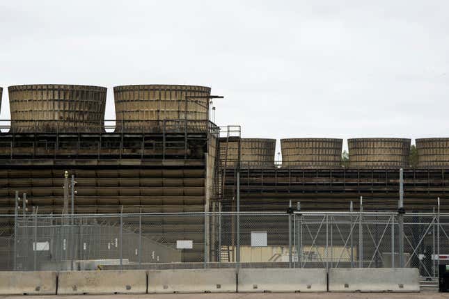 FILE - Cooling towers release heat generated by boiling water reactors at Xcel Energy&#39;s Nuclear Generating Plant, Oct. 2, 2019, in Monticello, Minn. Xcel Energy has been fined $14,000 related to leaks of radioactive tritium from its nuclear power plant at Monticello, Minnesota regulators announced Thursday, Dec. 14, 2023. (Evan Frost/Minnesota Public Radio via AP, File)