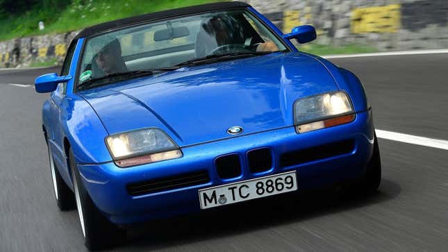 A blue BMW Z1 driving on a road