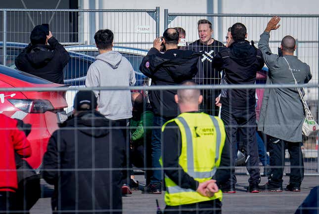 Tesla CEO Elon Musk, 4th from right, arrives at the Tesla Gigafactory for electric cars in Gruenheide near Berlin, Germany, Wednesday, March 13, 2024. Power has been restored to electric car manufacturer Tesla&#39;s factory near Berlin about a week after an outage believed to have been caused by arson, a network operator says. (AP Photo/Ebrahim Noroozi)