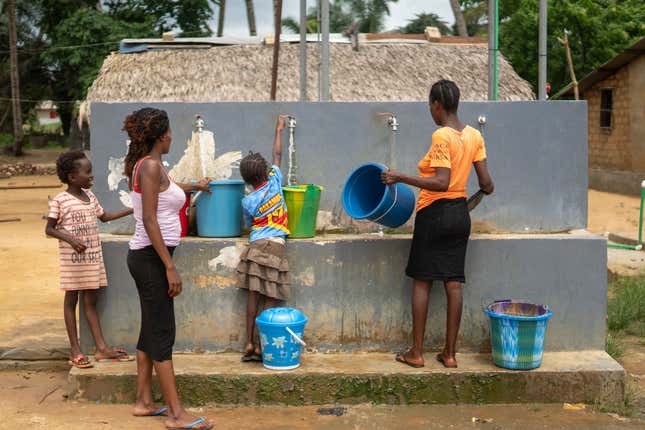 People collect water from a community pump in their village of Tshiende, which is affected by oil drilling, in Moanda, Democratic Republic of the Congo, Saturday, Dec. 23, 2023. (AP Photo/Mosa&#39;ab Elshamy)