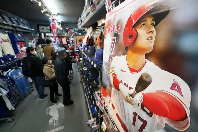 Customers shop around for character goods of Shohei Ohtani of the Los Angeles Dodgers at a sporting goods store, &quot;SELECTION,&quot; in Shinjuku district Wednesday, Dec. 13, 2023, in Tokyo. Ohtani agreed to a record $700 million, 10-year contract with the Los Angeles Dodgers. (AP Photo/Eugene Hoshiko)