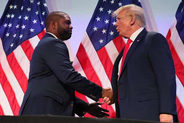 Rep. Byron Donalds shakes hands with former President Donald Trump at a Moms for Liberty Joyful Warriors summit on June 30, 2023 in Philadelphia, Pennsylvania. 
