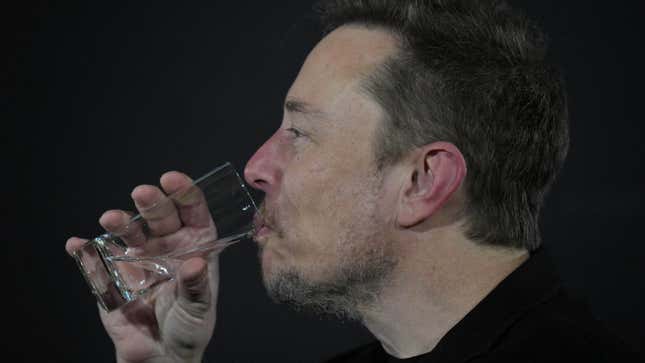 Elon Musk takes a drink of water. 