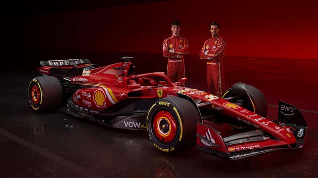 The SF-24 with Ferrari drivers Charles Leclerc (left) and Carlos Sainz (right) standing behind the car.