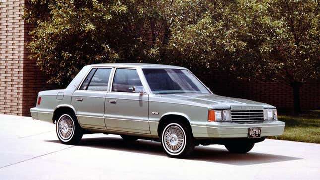 A photo of a silver Dodge Aries sedan. 