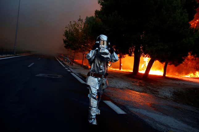 A firefighter in flame-resistant gear in Rafina.