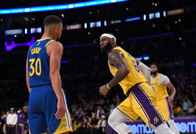 LeBron James #6 of the Los Angeles Lakers reacts after scoring during the second half against Stephen Curry #30 of the Golden State Warriors at Staples Center on October 19, 2021 in Los Angeles, California.