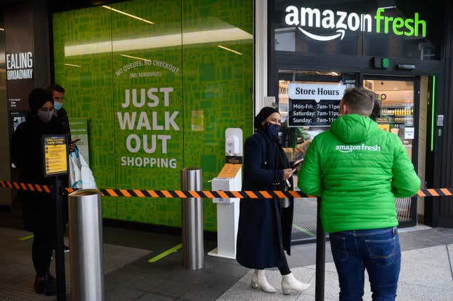 A customer and employee at an Amazon Fresh store. 