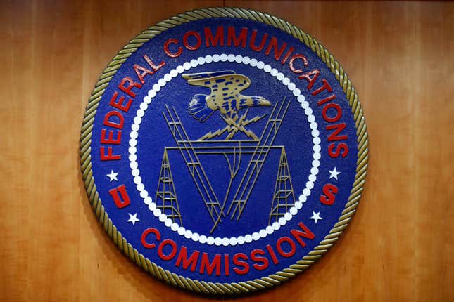 FILE - The seal of the Federal Communications Commission (FCC) is seen before an FCC meeting to vote on net neutrality, Dec. 14, 2017, in Washington. The Federal Communications Commission is outlawing robocalls that contain voices generated by artificial intelligence. The decision sends a clear message that exploiting the technology to scam people and mislead voters won’t be tolerated. (AP Photo/Jacquelyn Martin, File)