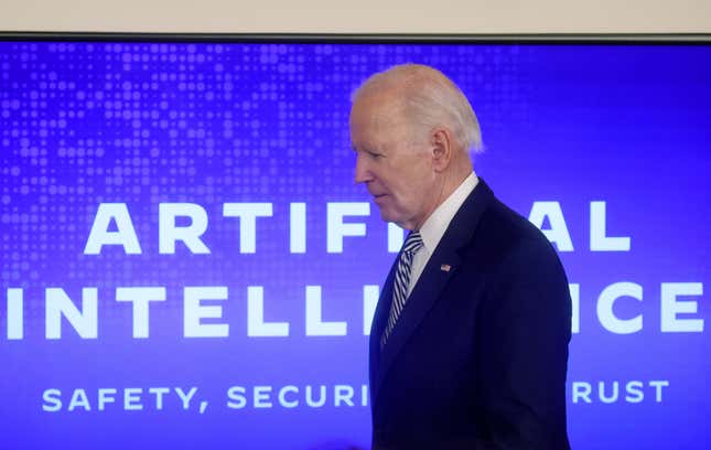 President Biden walks in front of screen displaying his artificial intelligence event