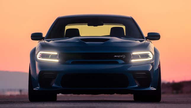 A photo of a blue Dodge Charger at sunset. 