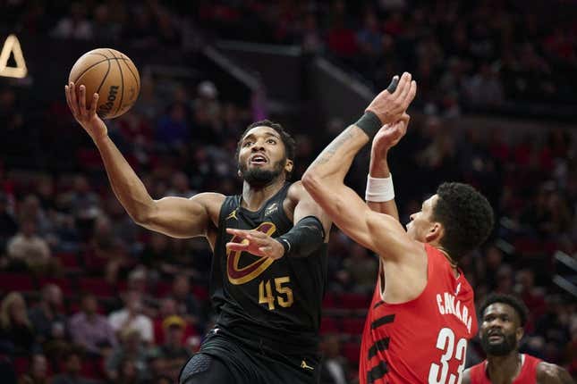 Nov 15, 2023; Portland, Oregon, USA; Cleveland Cavaliers guard Donovan Mitchell (45) drives to the basket during the second half against Portland Trail Blazers forward Toumani Camara (33) at Moda Center.