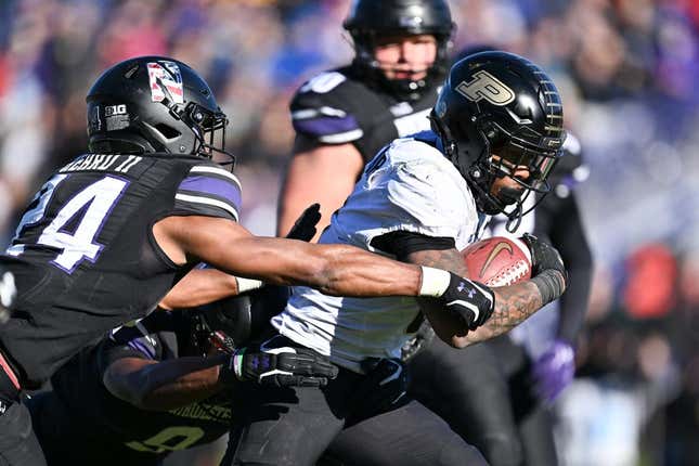 Nov 18, 2023; Evanston, Illinois, USA;  Purdue Boilermakers running back Tyrone Tracy Jr. (3) breaks a tackle by Northwestern Wildcats defensive back Rod Heard II (24) for a touchdown run in the third quarter at Ryan Field.