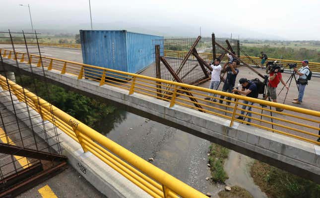 Journalists inspect the blockade on the bridge.