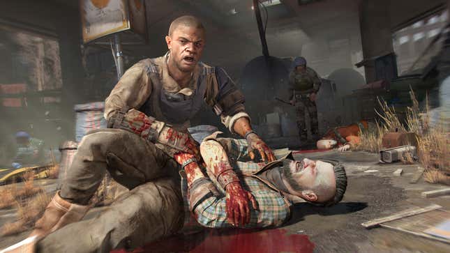 One guy kneels over a wounded guy on the ground in Dying Light 2 Stay Human.