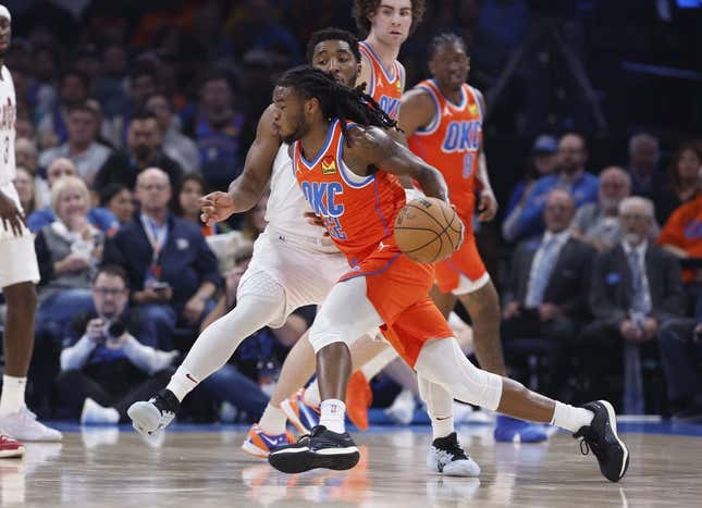 Nov 8, 2023; Oklahoma City, Oklahoma, USA; Oklahoma City Thunder guard Cason Wallace (22) drives to the basket around Cleveland Cavaliers guard Donovan Mitchell (45) during the second quarter at Paycom Center.